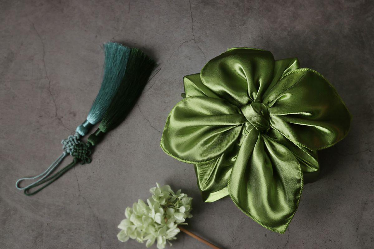 a box wrapped with olive color Bojagi.