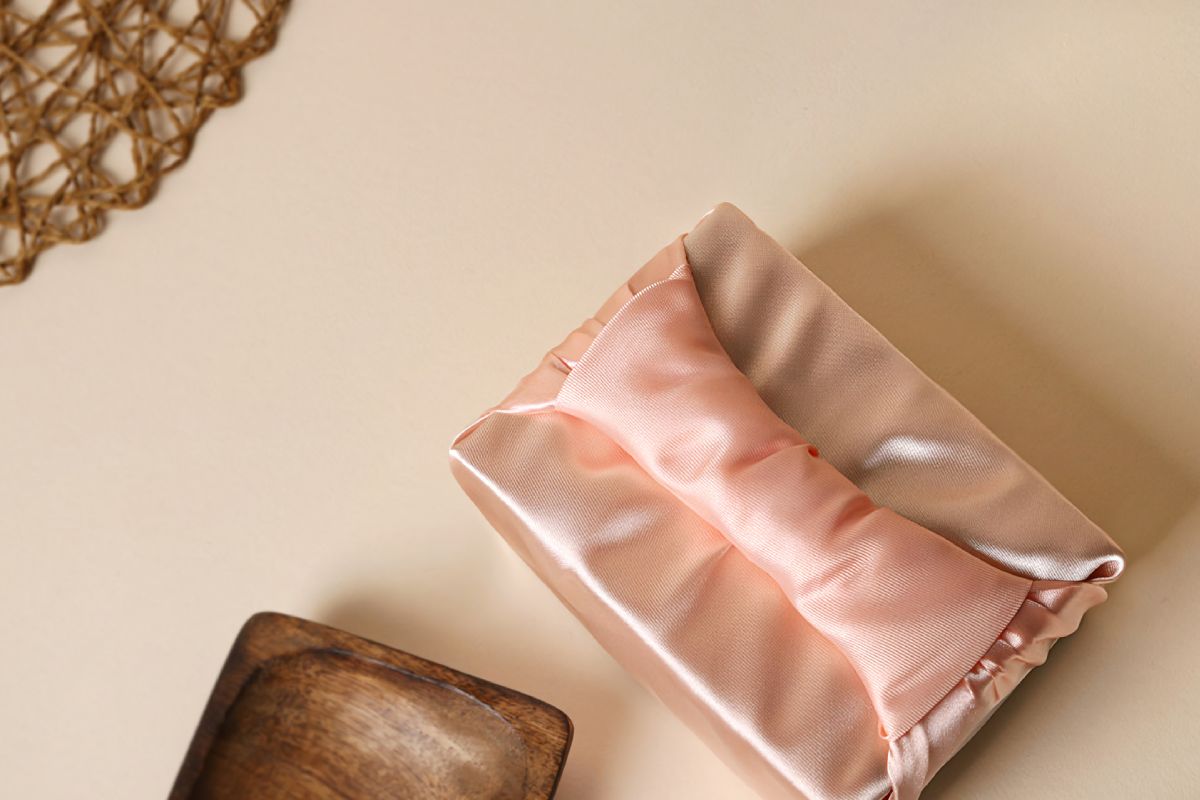 a box wrapped with apricot color Bojagi.