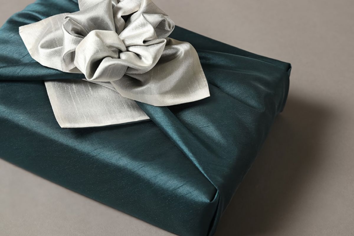 a rectangular boxe wrapped with dark green color Bojagi.