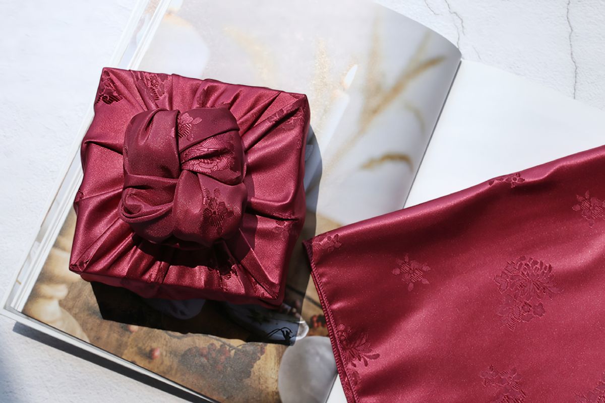 a rectangular box wrapped with red color Bojagi.